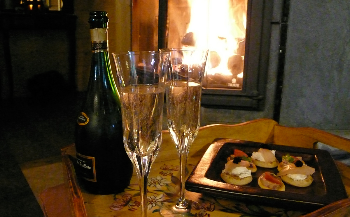 Relax with champaign in front of a roaring fire
