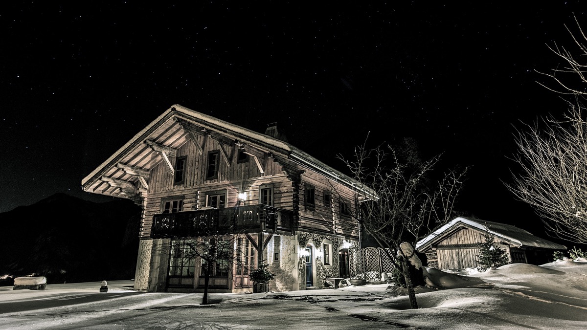 The beatiful chalet against a night backdrop